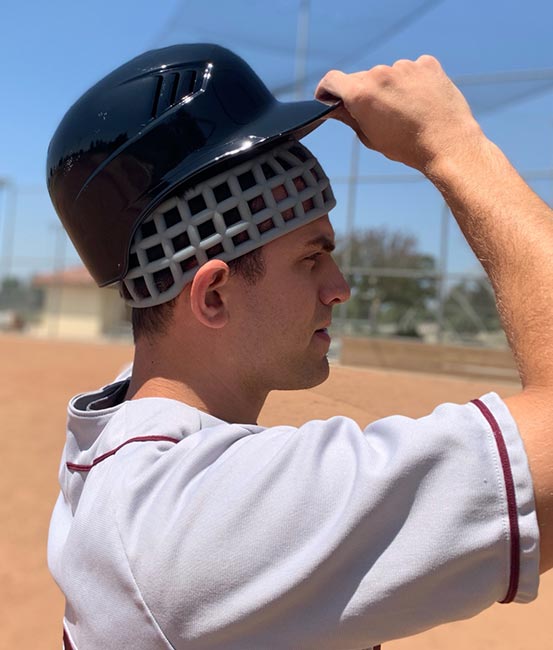 Baseball player wearing Head Net protective headgear under baseball helmet